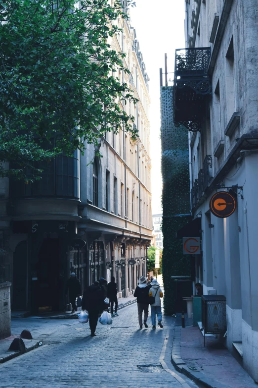 a cobblestone road lined with tall, old buildings