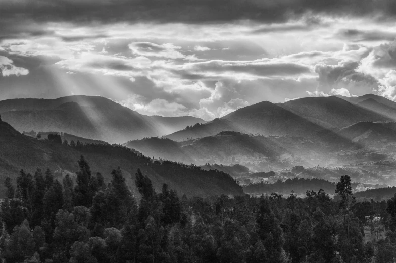 black and white po of mountains with cloudy sky