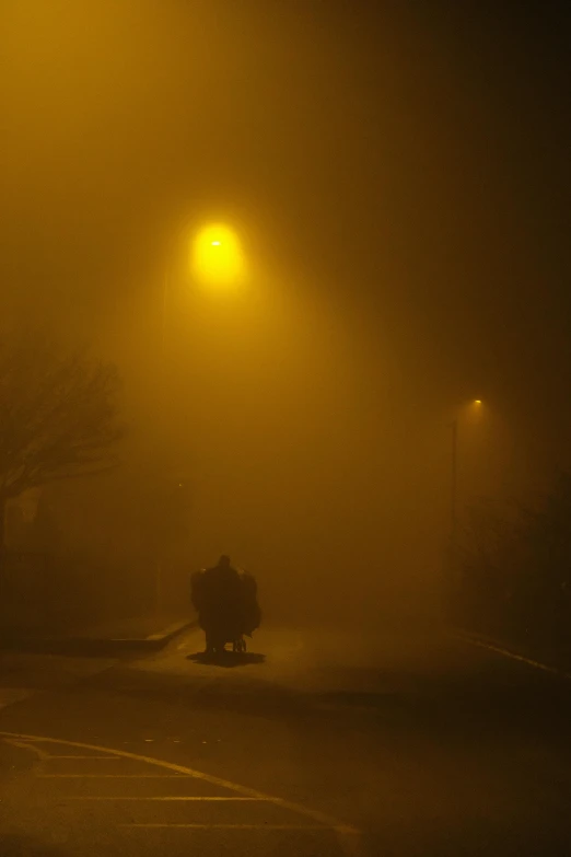 a night scene of an intersection on a foggy day