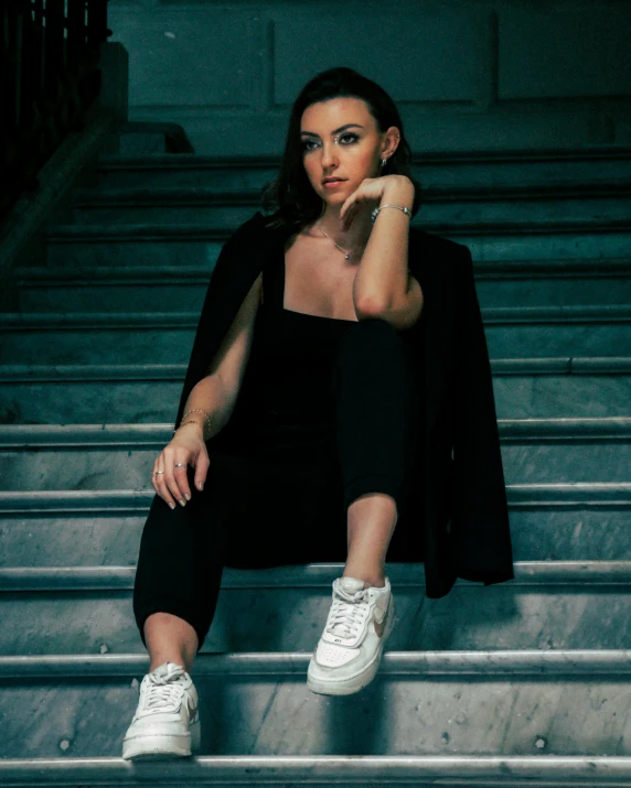 a woman sitting on top of some steps