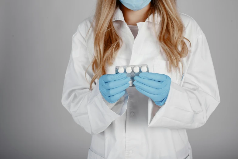 a person in a white coat is holding some dental equipment