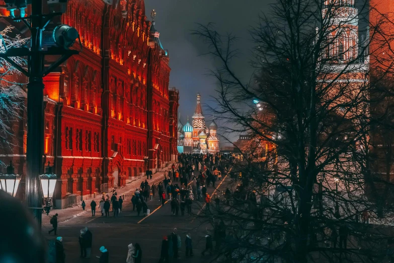 a dark and snowy city at night with tall buildings