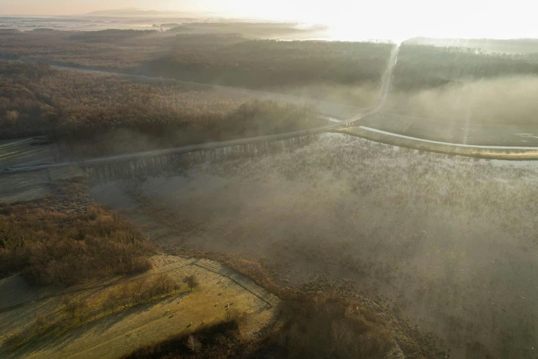 aerial view of road and mountains in a foggy landscape