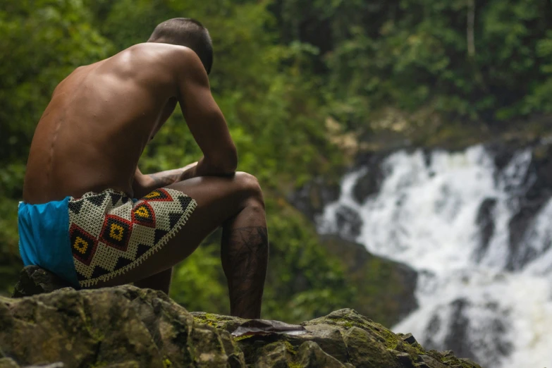 a person that is sitting by some water