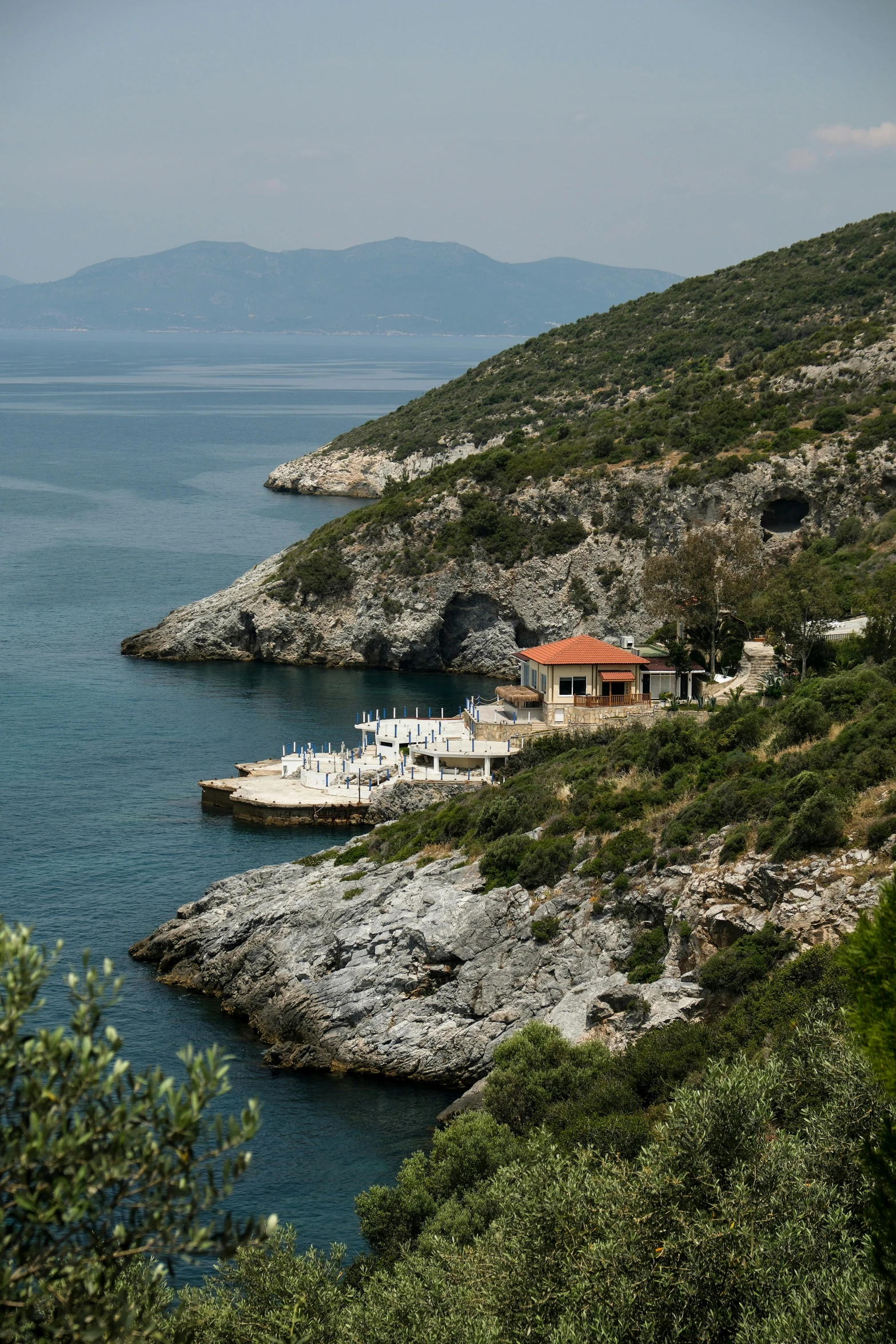 the house on the edge of a cliff overlooking the water