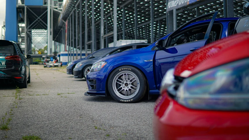 a parking lot with parked cars in front of a stadium