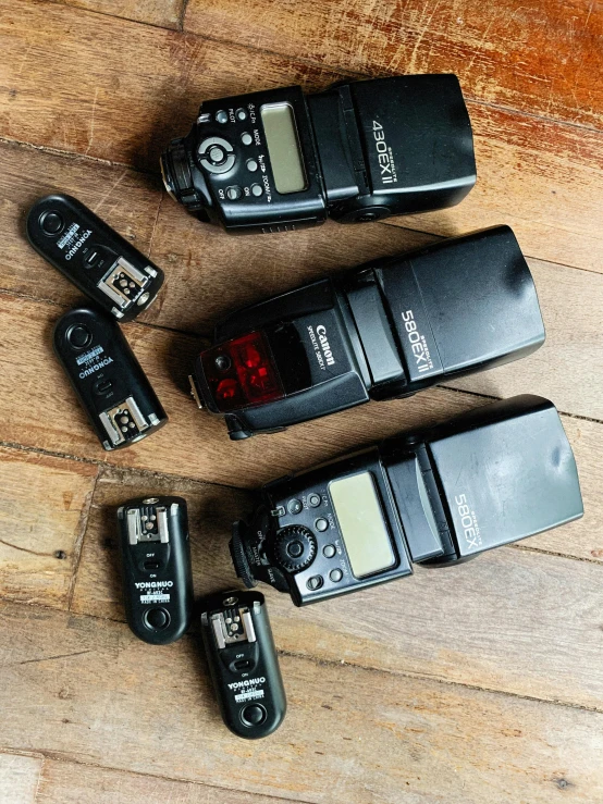 three older digital recorders are laid out on the table