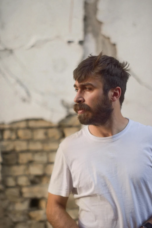 a man with a beard wearing white shirt