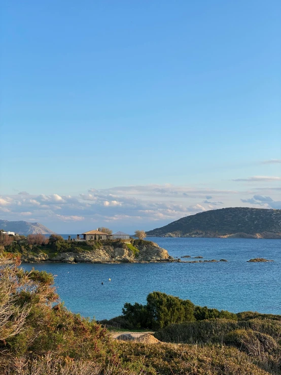 several small island on blue waters in a rocky terrain