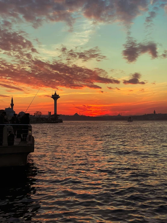 the sunset casts on the water and a boat is out in front