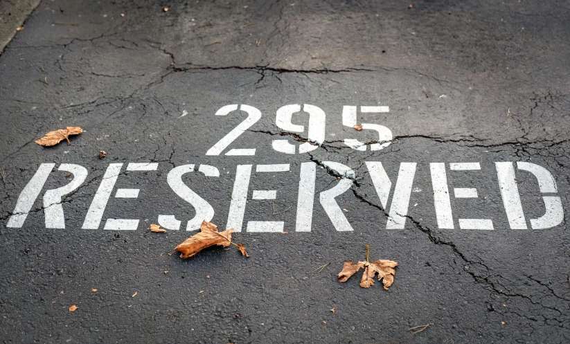 a street with the words reserved and leaf littering on it