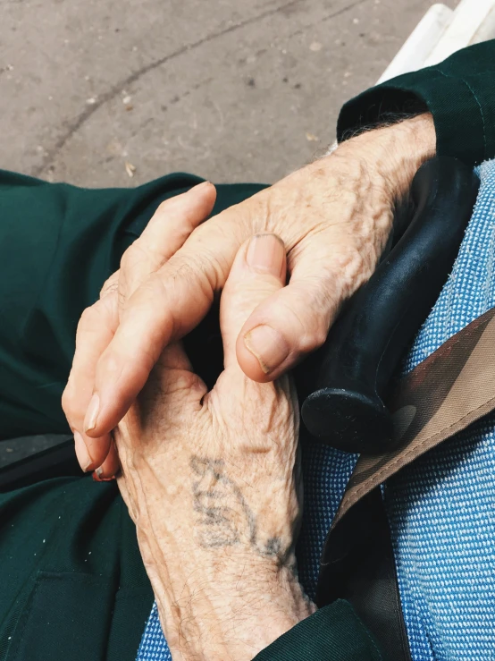 an older gentleman holding onto his hand as if in love