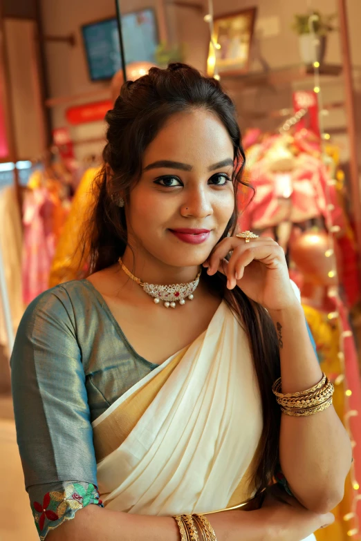 beautiful indian woman in traditional saree posing for a po