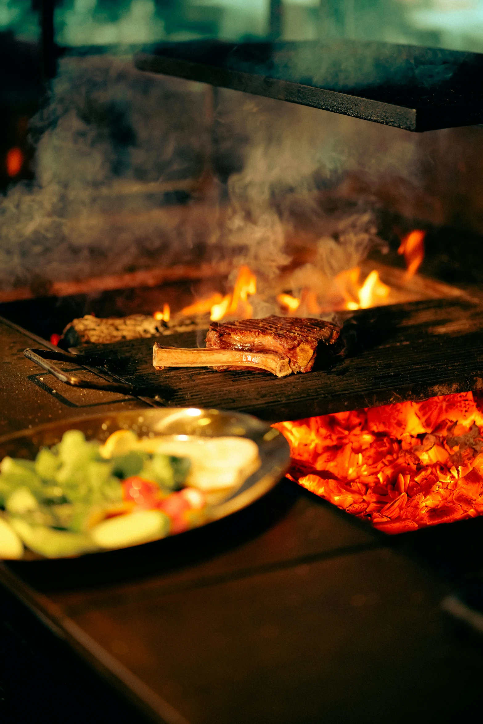 a couple plates of food are sitting outside on some kind of grill