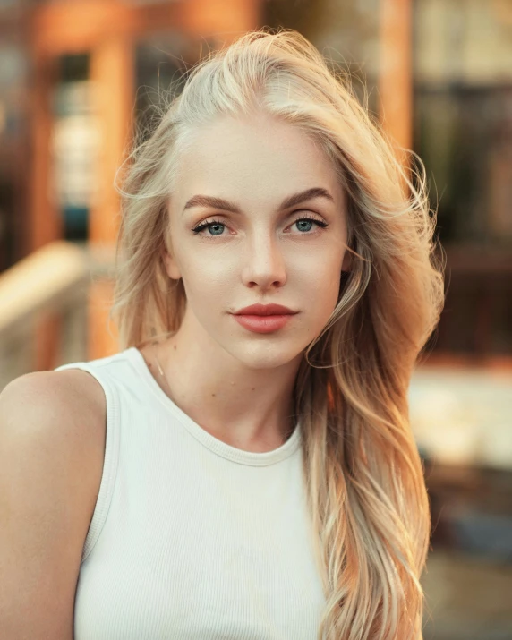 a woman with blonde hair is posing for a portrait