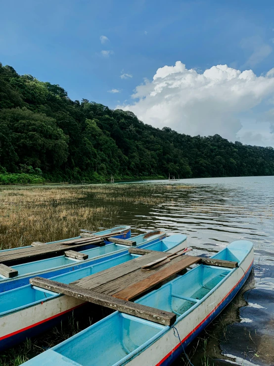 three boats parked next to each other on the shore