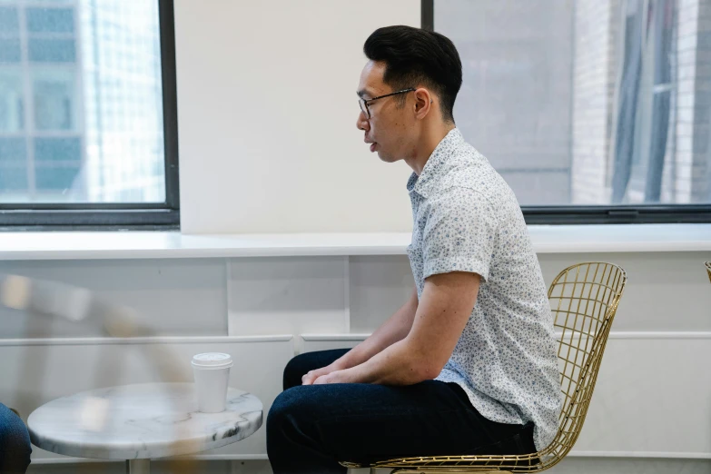 a man sitting at a table with a laptop computer