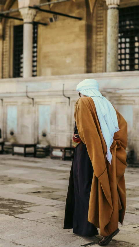 a woman walks in front of the building