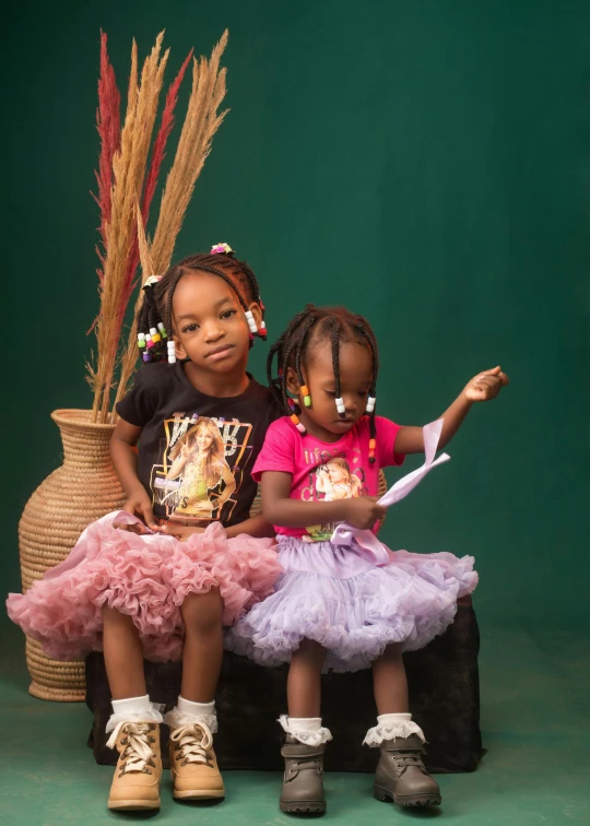 two s sit on top of a small chair