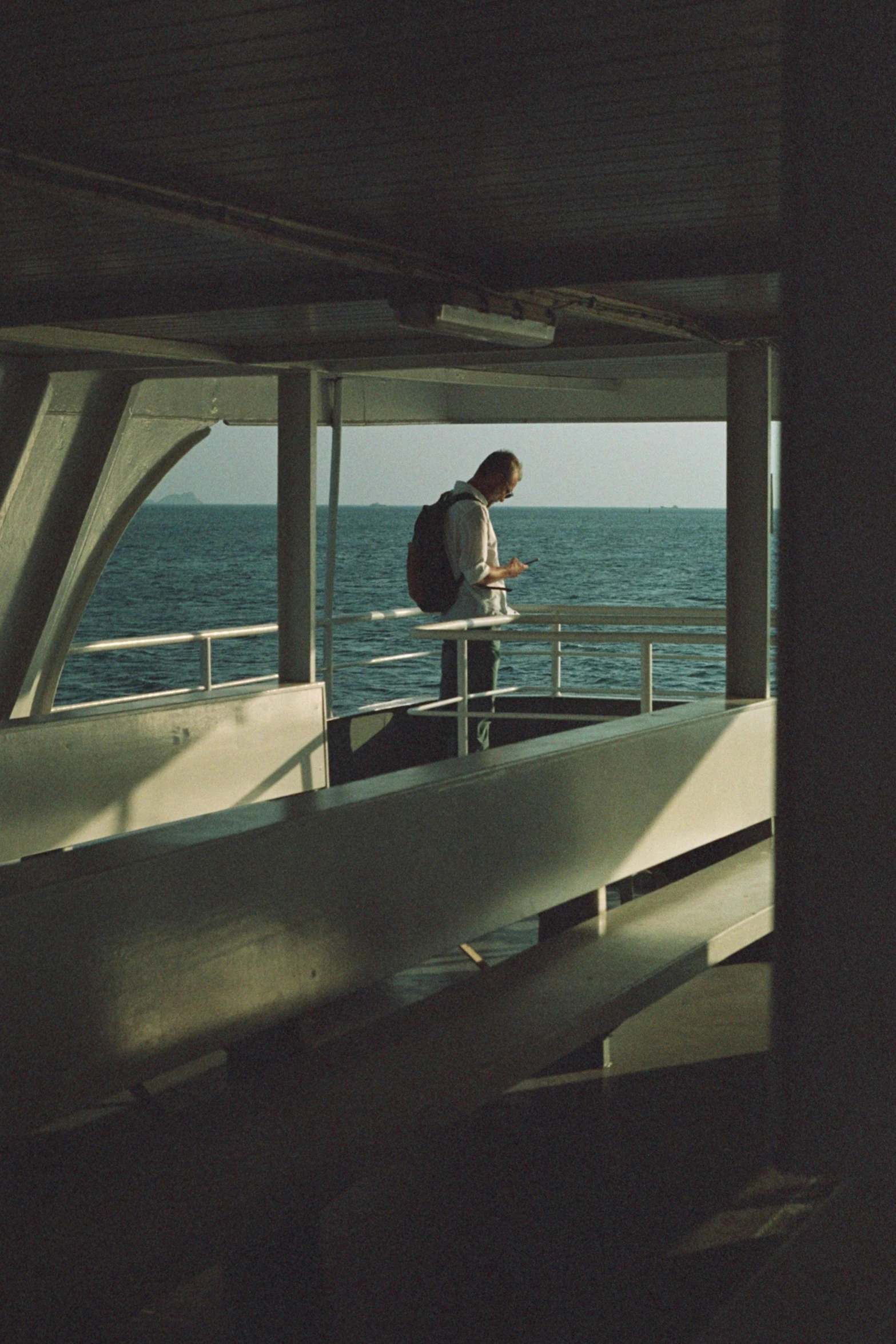 a man standing on the deck of a large boat