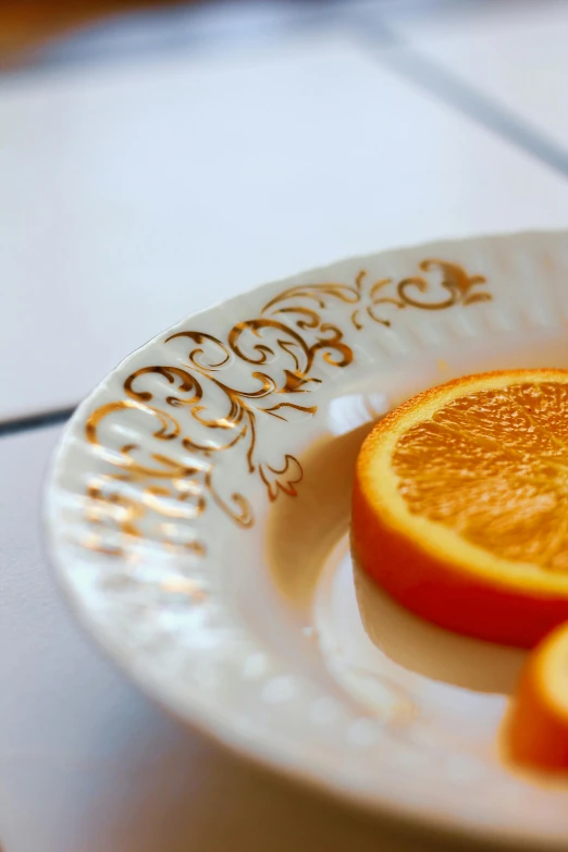 oranges in a plate with writing on them