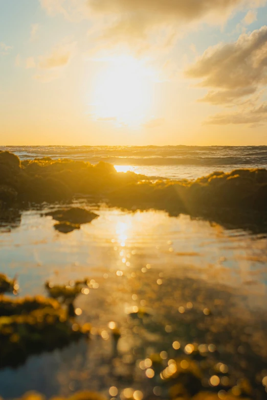 the sun is setting on the ocean and water