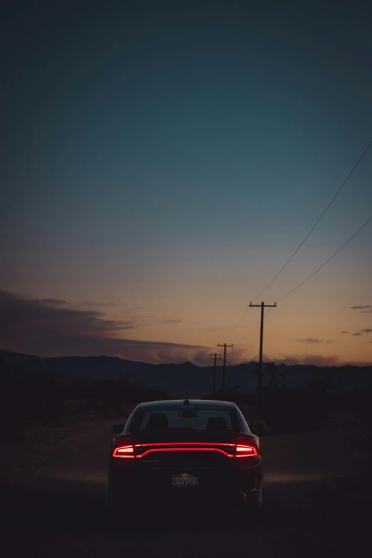 a car driving down the road at night