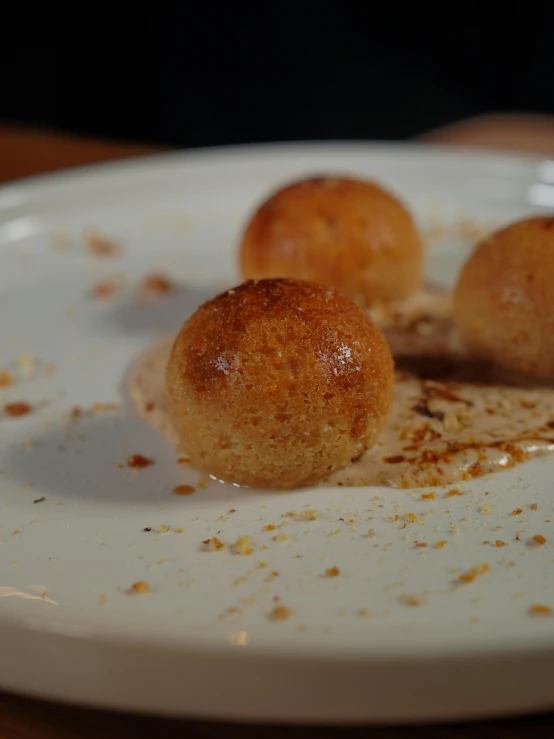 three small food items are on a white plate