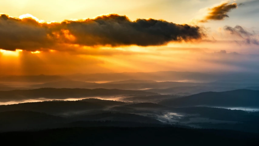 the sun shines through the clouds above the mountains