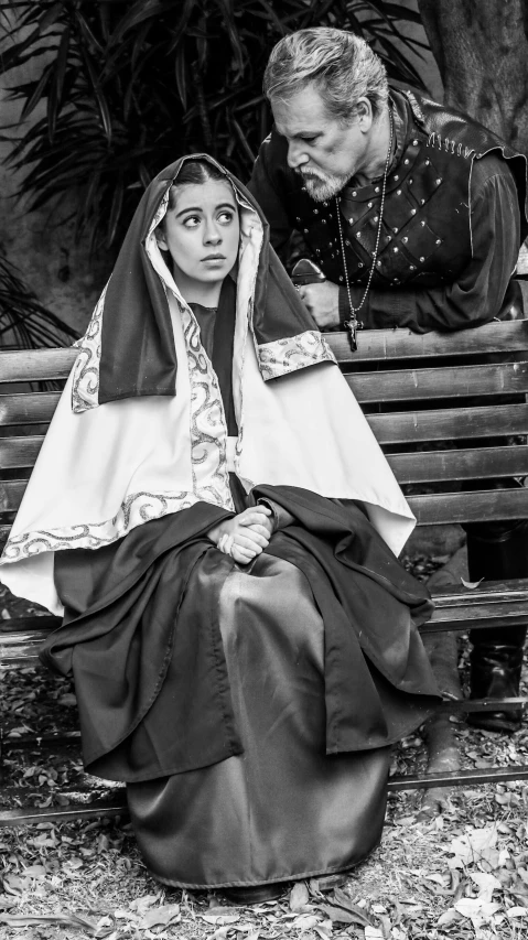 a man sitting next to a woman in a dress