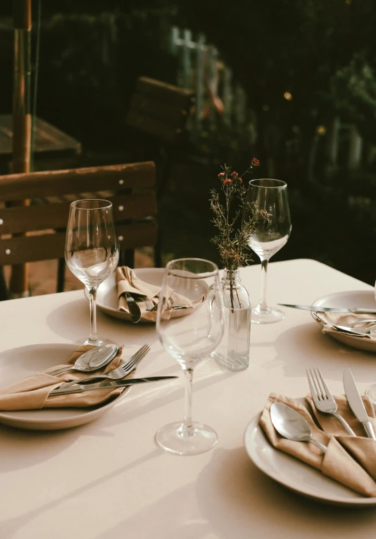 a glass of white wine sits on top of a table