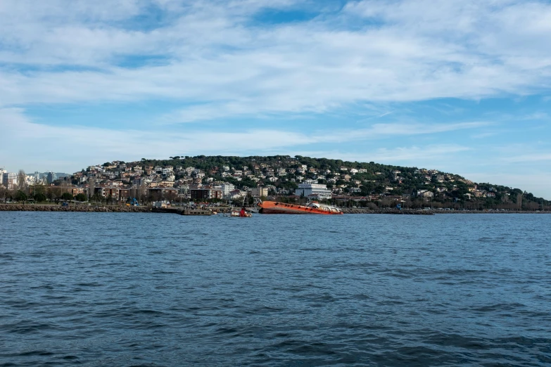 a tug boat near a city by the water