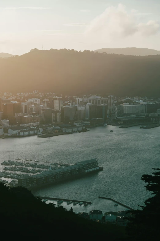 a boat is docked in the bay near a town