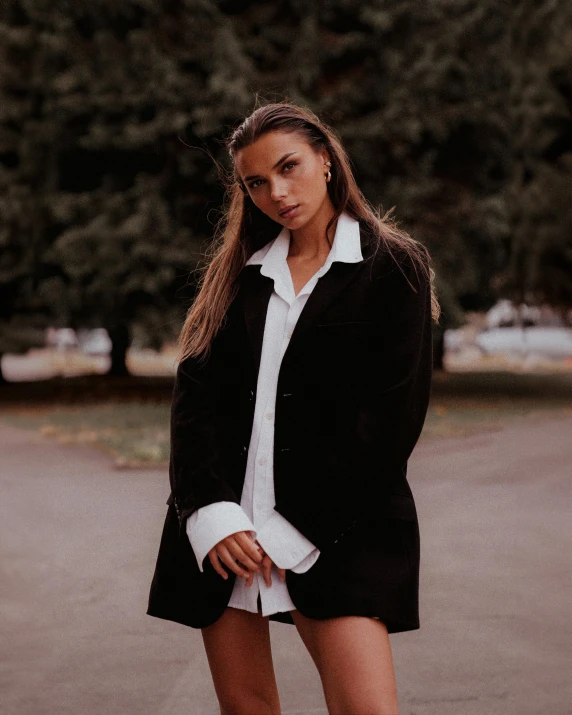 a woman in a black jacket standing outside