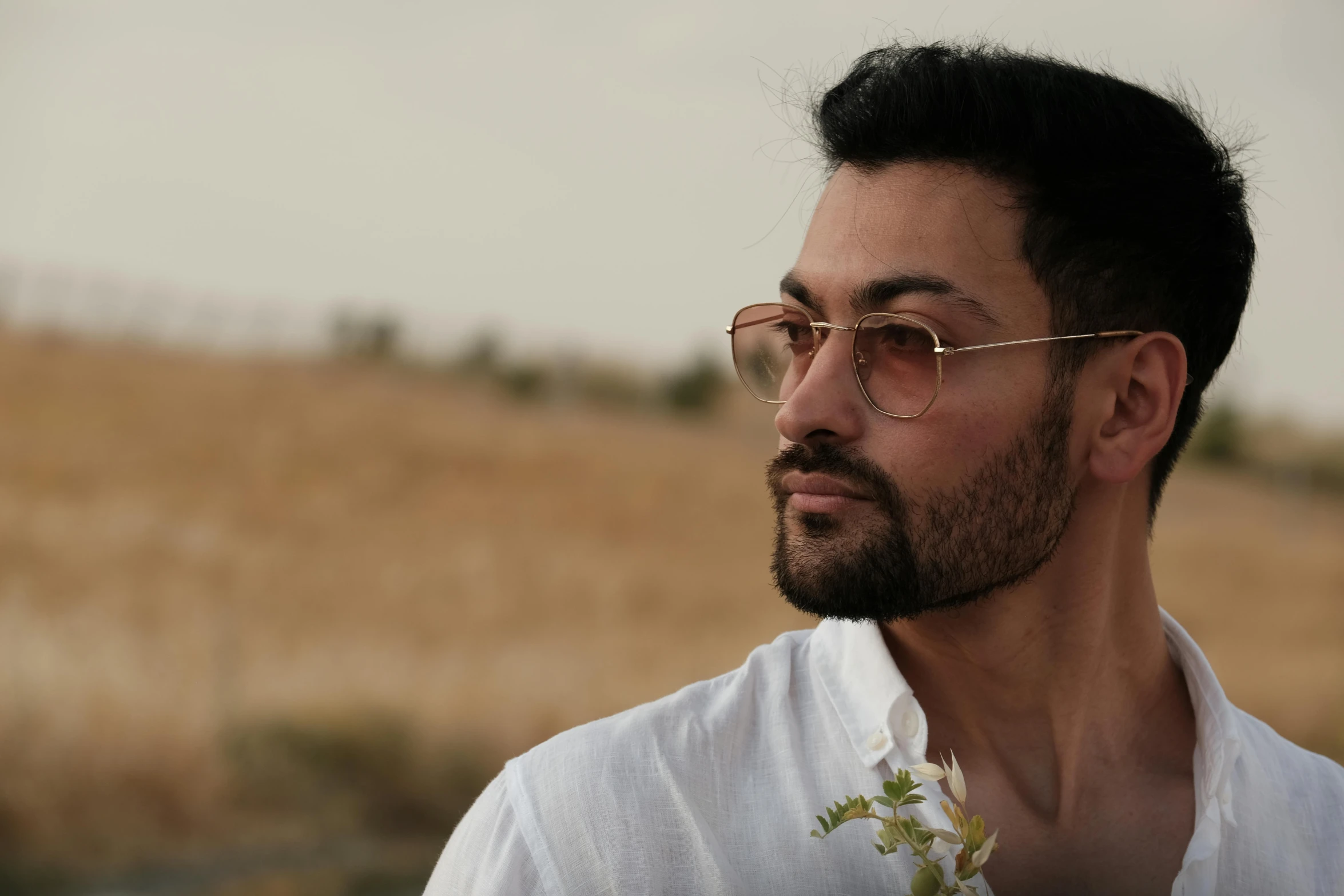 man wearing glasses with hair pulled back and beard