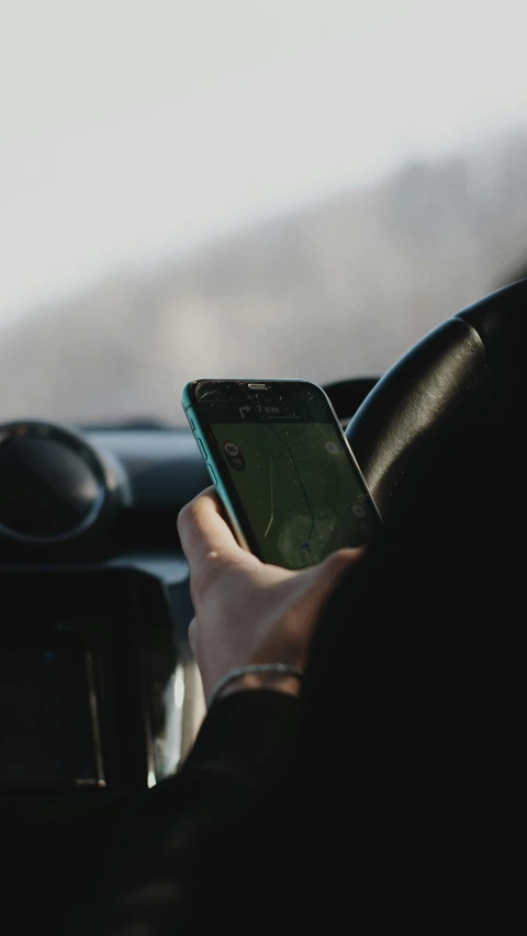 a person in a car holding a cell phone