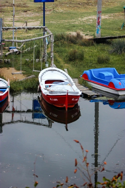 two red boats are parked next to each other