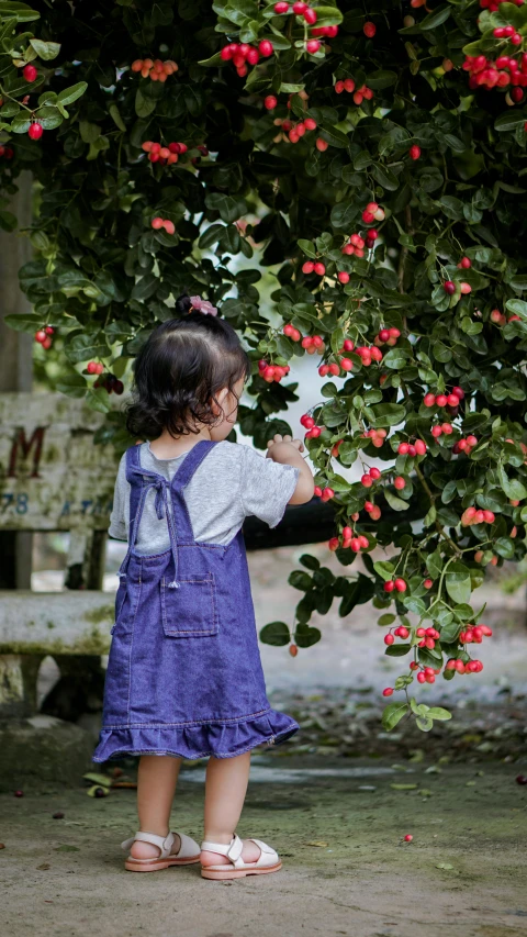 a little girl standing outside on the ground