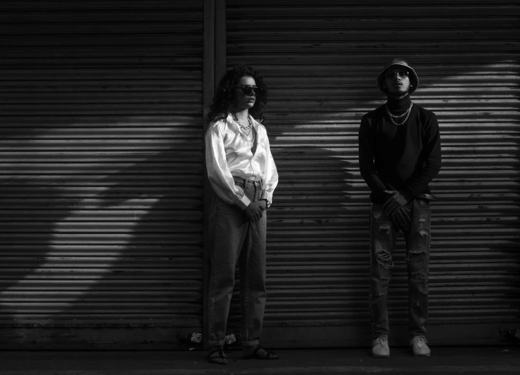 two men are standing in front of a garage door