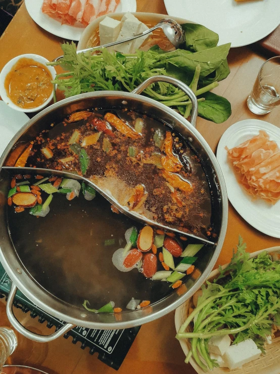 a large pot filled with lots of food on top of a table