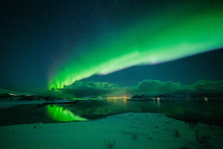 green lights shine brightly on the aurora display