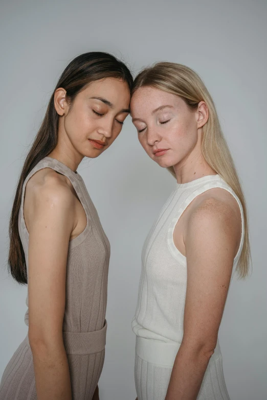 two beautiful young women standing next to each other