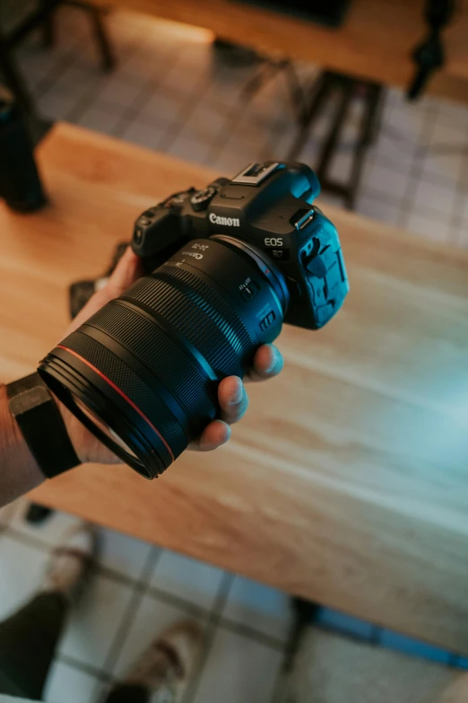 a man with his hand in the camera holding an object