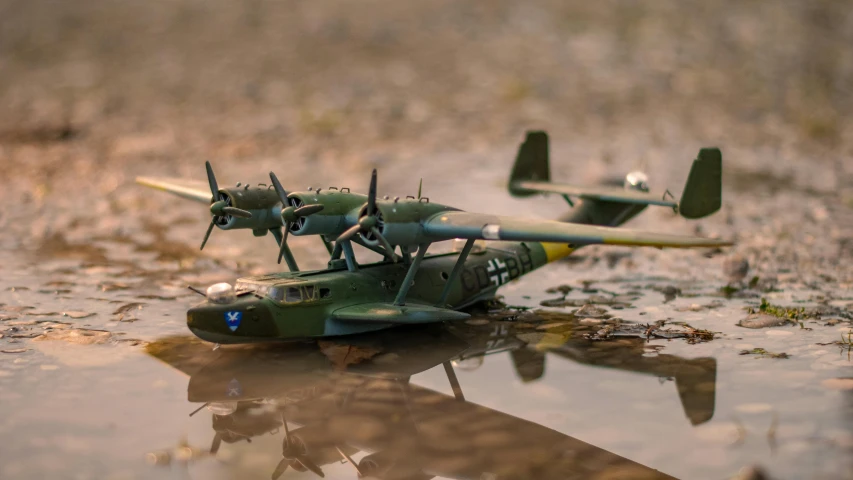 one small green airplane sitting on top of the ground