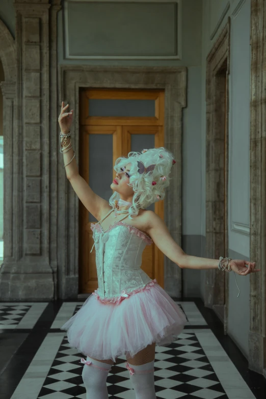 a woman in pink tutu is posing for the camera