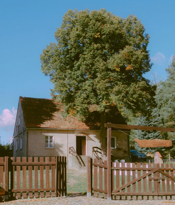 there is a horse stable behind the wooden fence