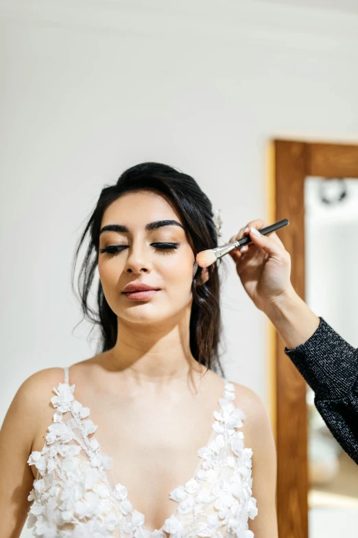 a woman holding a small mirror with her face up