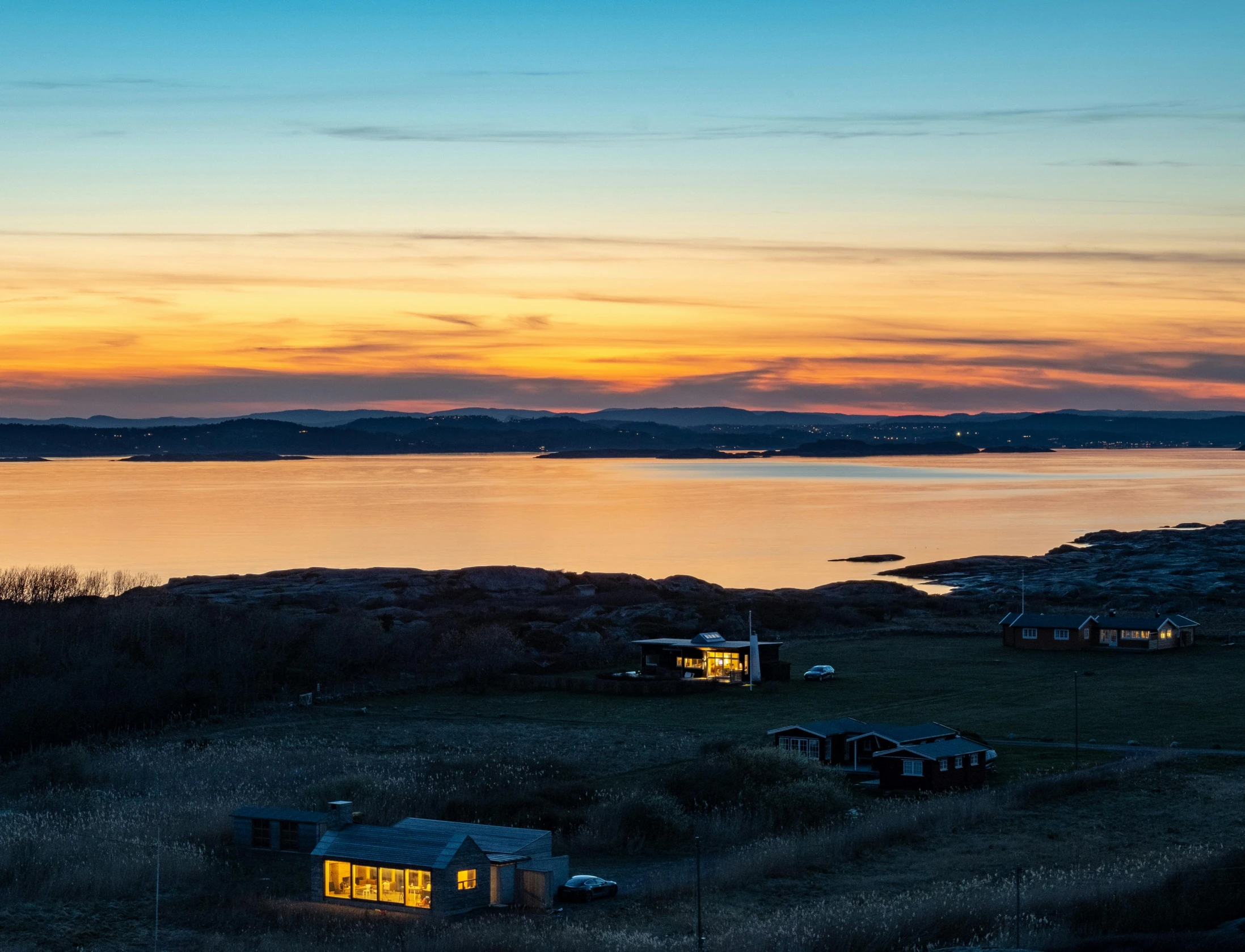 a couple of cabins that are in the grass