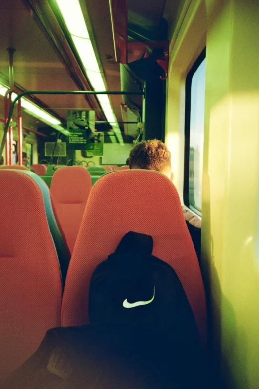 seats in a train with a black backpack