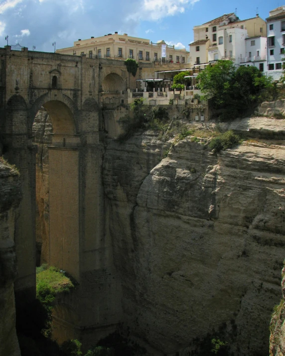 bridge on cliff overlooking part of town and cliffs